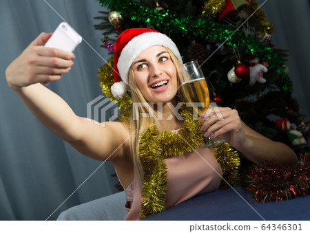 Young woman is posing for selfie in New Year night 64346301