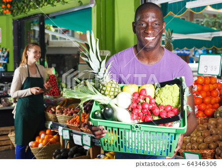 Man with basket in fruit market 64346306