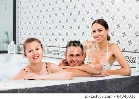Three friends relaxing at spa, enjoying company 64346336