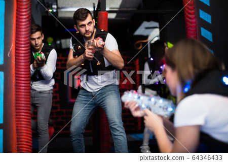 Emotional guy playing laser tag Emotional guy playing laser tag 64346433