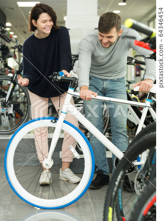 male and female choosing sport bicycle male and female choosing sport bicycle 64346454