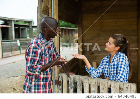 Woman having unpleasant talk with neighbour 64346493