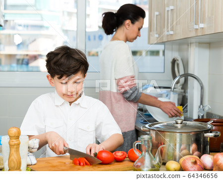 Son assisting to mom to cook Son assisting to mom to cook 64346656