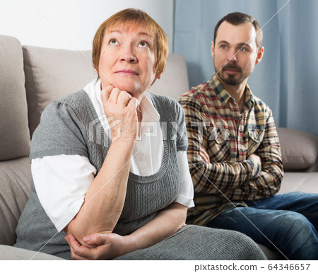 Elderly mother and son quarrel 64346657