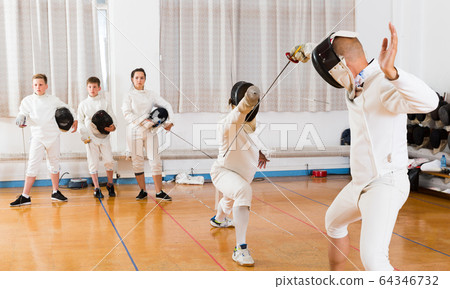 fencers watching at fencing duel 64346732