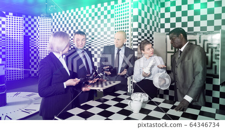 Toned image of businesspeople discussing near chessboard 64346734