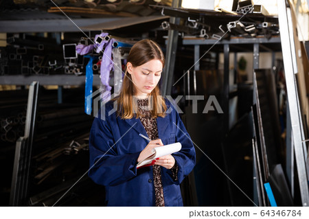 Woman counts metal profile pipe in a warehouse Woman counts metal profile pipe in a warehouse 64346784