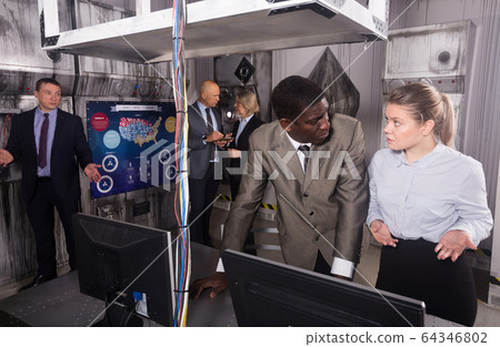 Colleagues solving puzzle in quest room Colleagues solving puzzle in quest room 64346802