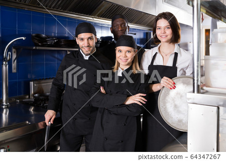Portrait of glad kitcheners and woman waiter Portrait of glad kitcheners and woman waiter 64347267