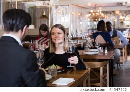 Lovely couple is dining together 64347322