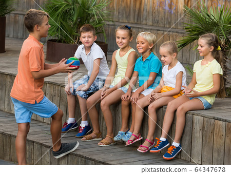 children playing with small ball outdoor. 64347678