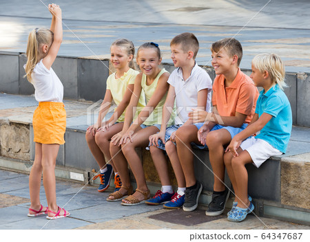 cheerful kids playing charades outdoors cheerful kids playing charades outdoors 64347687
