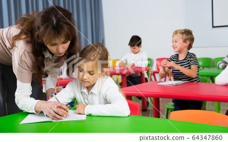 Teacher at lesson with school kids 64347860