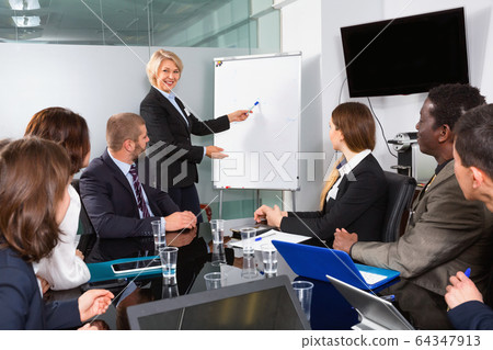 Elegant mature businesswoman discussing new project with his tea 64347913