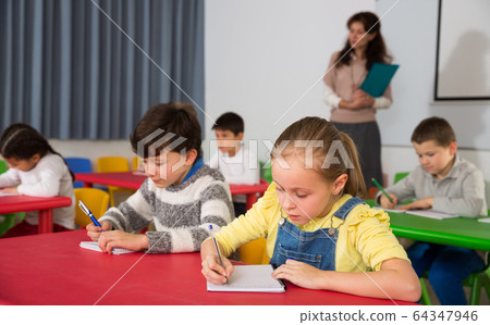 Students writing at lessons Students writing at lessons 64347946