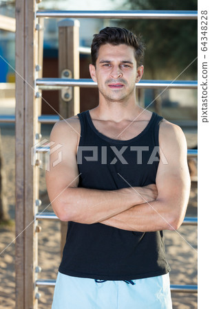Sporty man near outdoor wall bars Sporty man near outdoor wall bars 64348228
