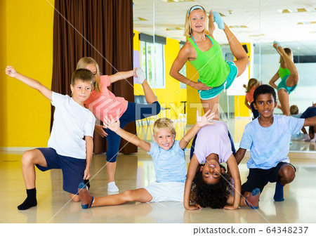 Positive children in dance studio smiling and having fun 64348237
