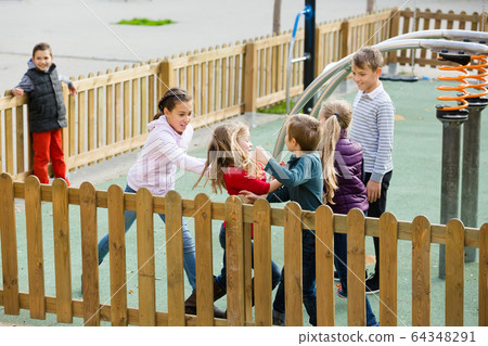 Excited kids running around while playing 64348291