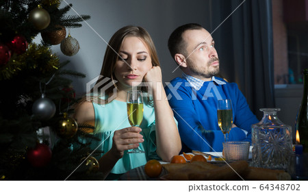 Quarrel couple having dinner at Christmas night 64348702