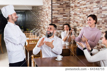 Smiling chef listens to praise of the food Smiling chef listens to praise of the food 64348733