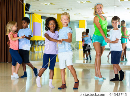 Little boys and girls dancing pair dance in the ballet studio Little boys and girls dancing pair dance in the ballet studio 64348743