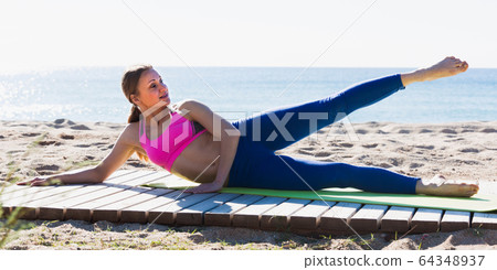 Woman 28-35 years old is practicing yoga Woman 28-35 years old is practicing yoga 64348937