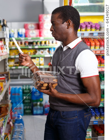 African man shopping with list 64349017