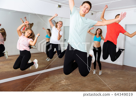 Happy teens jumping in choreography class Happy teens jumping in choreography class 64349019