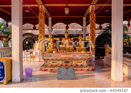 Thailand,Nan - Febury 28, 2020: Golden Three Buddhas for wishes at Wat Phra That Chae Haeng Thailand,Nan - Febury 28, 2020: Golden Three Buddhas for wishes at Wat Phra That Chae Haeng 64349187