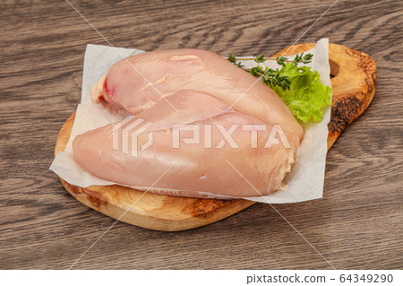 Raw chicken breast over board Raw chicken breast over board 64349290
