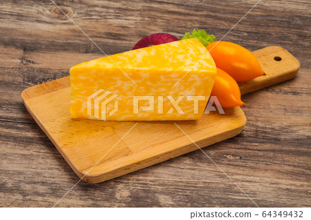 Marble cheese  triangle over wooden 64349432