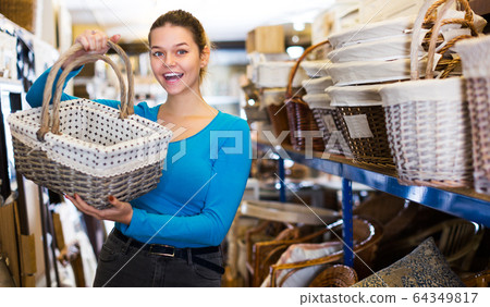 customer standing with wicker basket 64349817