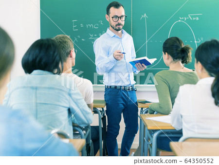 Male teacher giving lecture for students Male teacher giving lecture for students 64350552