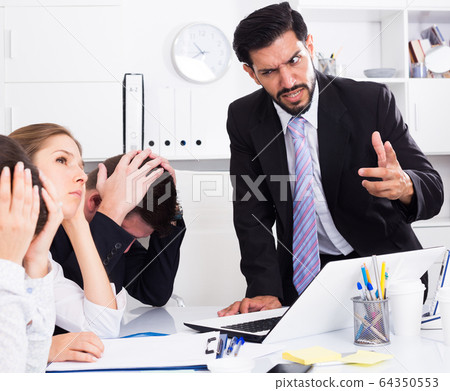 Outraged manager with colleagues at meeting 64350553