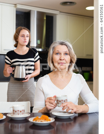 Mature woman at kitchen Mature woman at kitchen 64350561