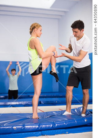 Trampoline coach training woman 64350890