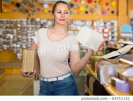 Housewife is choosing light boxes Housewife is choosing light boxes 64351181