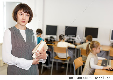 Strict female teacher in computer class Strict female teacher in computer class 64351262