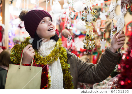 Ordinary female customer with Christmas gifts 64351395