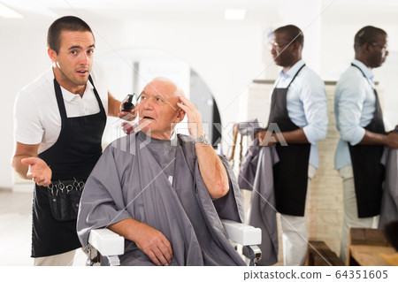 Senior man unpleasantly surprised by haircut Senior man unpleasantly surprised by haircut 64351605