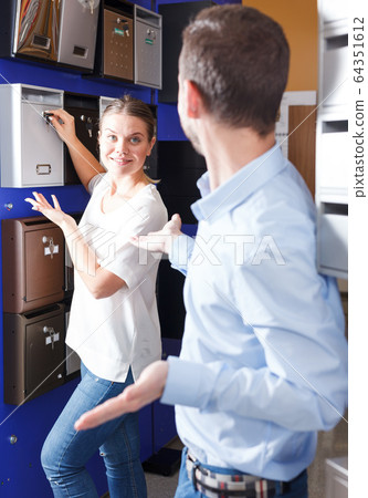Girl with boyfriend looking for mailbox Girl with boyfriend looking for mailbox 64351612