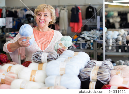 female choosing multicolored thread for knitting female choosing multicolored thread for knitting 64351631
