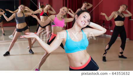 Women dancing zumba in modern dance class Women dancing zumba in modern dance class 64351632