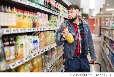 Man purchasing sweet soft drinks Man purchasing sweet soft drinks 64351704