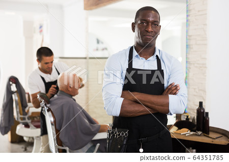 Confident African man hairdresser Confident African man hairdresser 64351785