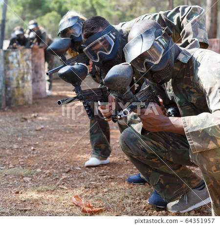 Outdoor portrait of paintball team 64351957