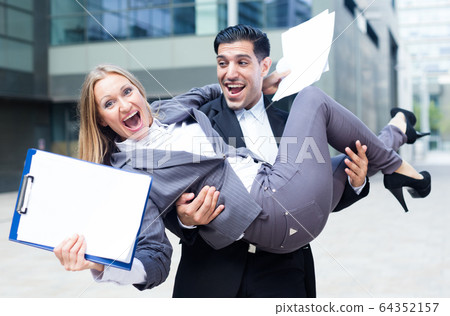 Businesswoman is on hands of her partner because they are signed successful contract 64352157