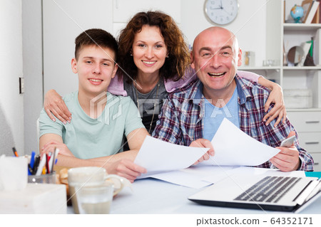 Happy family with papers Happy family with papers 64352171
