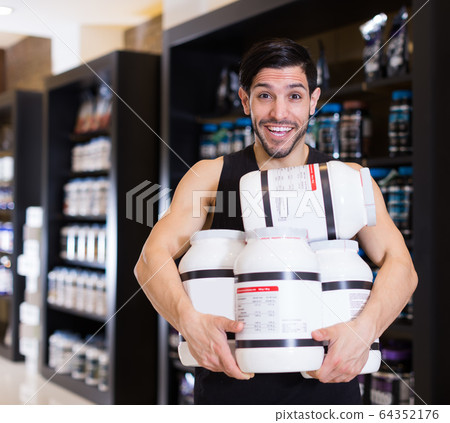buyer holding stack of sport nutrition 64352176