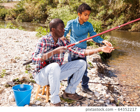 Man and his son fishing Man and his son fishing 64352217